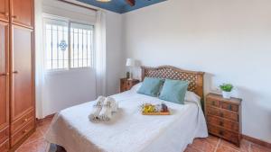 a bedroom with a bed with shoes on it at Villa Manolo Torrox by Ruralidays in Torrox +50 photos