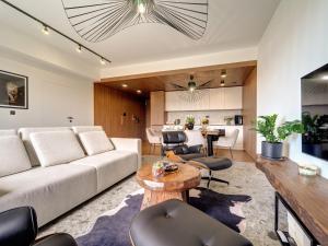 a living room with a couch and a table at Miral Apartament nad Jeziorem Czorsztyńskim in Kluszkowce