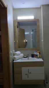 a bathroom with a sink and a mirror at Two bedroom Apartment in Bouznika Beach in Bouznika