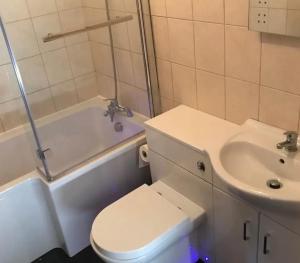 a bathroom with a toilet and a sink at Swallow cottage in Howden +15 photos