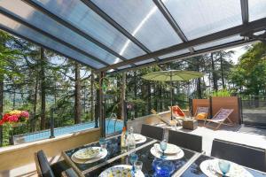 a patio with a table and chairs and a pool at Gîte La Tournelle in Crest