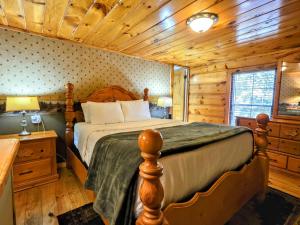 a bedroom with a bed in a log cabin at The Skinners Cabin Hot Tub Fireplace Grill in Townsend +53 photos