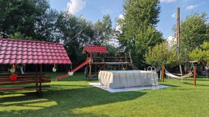 a park with a swing set and a playground at Casa Maya in Săsciori