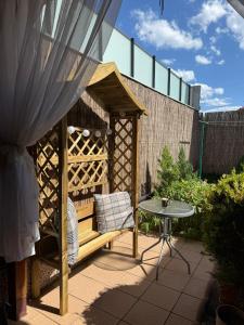 a wooden gazebo with a table in a garden at Casa Atlas in Eforie Sud