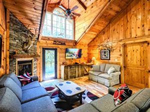 a living room with couches and a fireplace in a cabin at The Skinners Cabin Hot Tub Fireplace Grill in Townsend