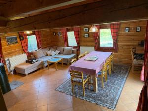 a living room with a table and a couch at Chalupa Pohoda Slovenský raj Hrabušice with sauna in Hrabušice