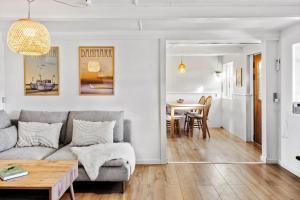 a living room with a couch and a table at 4024-Stege-Rabylille-Strandvej-14 in Stege