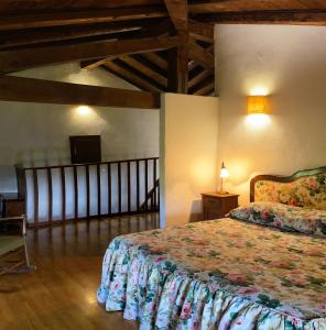 a bedroom with a bed in a room with wooden ceilings at La Torre della Casaforte Bergum alle porte di Cividale del Friuli in Cividale del Friuli
