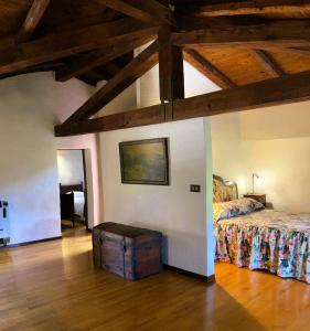 a bedroom with a bed and a wooden ceiling at La Torre della Casaforte Bergum alle porte di Cividale del Friuli in Cividale del Friuli