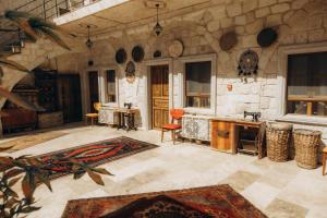 a large room with a stone wall and a kitchen at Timur inn Cappadocia in Göreme