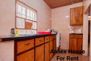a kitchen with a counter and a sink and a window at Annex House For Rent in Manjai Kunda