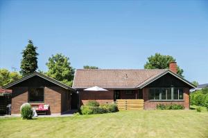 a brown brick house with a grass yard at R614-Rodvig-Stevns-Strandvaenget-1 in Rødvig
