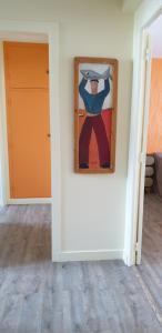 a painting of a man hanging on a wall at A 2 pas des iles à Concarneau in Concarneau