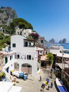 a white house on a hill next to the water at Villa Marea by My Villa Collection in Capri