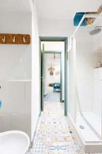 a bathroom with a shower and a toilet and a sink at Villa Marea by My Villa Collection in Capri +19 photos