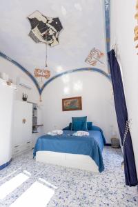 a bedroom with a blue bed with a blue comforter at Villa Marea by My Villa Collection in Capri
