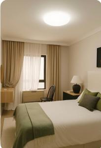 a hotel room with a bed and a window at Stay&view Santarém in Santarém