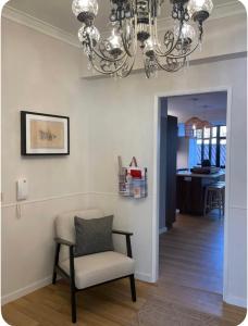 a chair and a chandelier in a living room at Stay&view Santarém in Santarém +5 photos