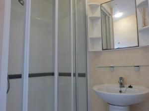 a bathroom with a shower and a sink at Northfield Holiday Park in Borth +85 photos