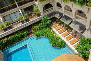 an aerial view of a hotel with a swimming pool and chairs at The Evren, Vagator in Vagator