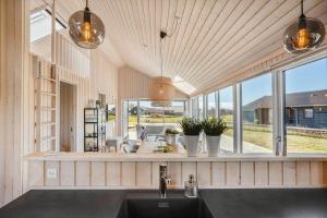 a kitchen with a sink and a large window at 8218-Lundby-Soloje-Strandvej-20 in Lundby
