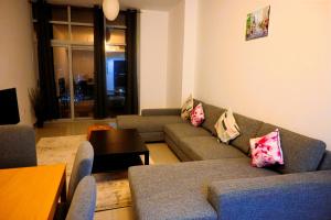 a living room with couches and a table at Superb Family Friendly Beach-Front Whole Flat, Great Views in Dubai
