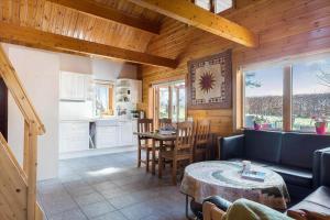 a living room with a table and a kitchen at 8163-Praesto-Kohavevej-3 in Præstø