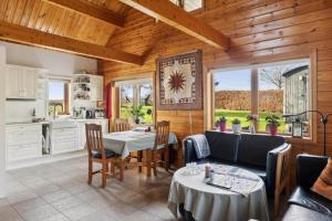 a kitchen and living room with a table and chairs at 8163-Praesto-Kohavevej-3 in Præstø +24 photos