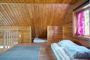 a wooden room with a bed and a window at 8163-Praesto-Kohavevej-3 in Præstø