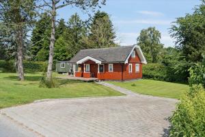 a red house with a driveway in front of it at 8163-Praesto-Kohavevej-3 in Præstø