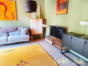 a living room with a couch and a tv at Villa Sandäng in Löderup