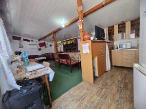 a room with a kitchen with a counter and a table at Erisia in Horezu