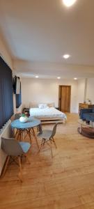 a bedroom with a bed and a table and chairs at Apartament Alcatraz parter 40m in Kamienna Góra
