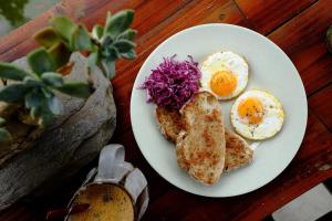 a plate of eggs and bread on a table at Nương Homestay in Sa Pa +40 photos