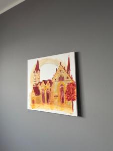a painting of a church on a wall at Pader-Motel in Paderborn