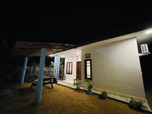 a house lit up at night with a porch at 2nd Home Villa in Pottuvil