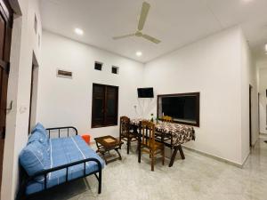 a living room with a table and a dining room at 2nd Home Villa in Pottuvil