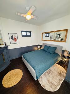 a bedroom with a bed with a ceiling fan at Le Pent House Limoges in Limoges