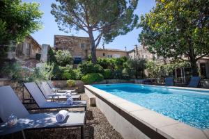 a swimming pool in the backyard of a house at La Regalido in Fontvieille