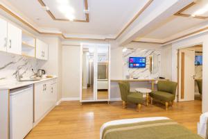 a kitchen and living room with a table and chairs at TAKSİM HAVANA HOTEL SUİTES in Istanbul