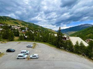 a group of cars parked in a parking lot at Studio cosy à Vars, 2 couchages, proche pistes - FR-1-330B-182 in Vars