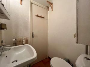 a white bathroom with a sink and a toilet at Studio cosy à Vars, 2 couchages, proche pistes - FR-1-330B-182 in Vars