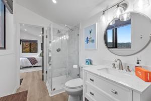 Un baño con inodoro, lavabo y espejo. en BK Lane - Harrison, en Harrison 12 fotos más