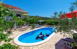 a swimming pool with a dolphin in the water at Beautiful Home In Sibenik in Šibenik