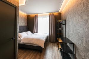 a small bedroom with a bed and a window at Centrum Hotel in Akureyri