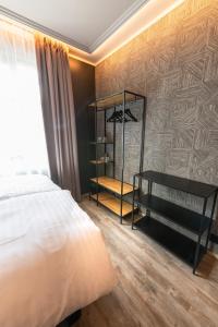 a bedroom with a bed and a wooden floor at Centrum Hotel in Akureyri