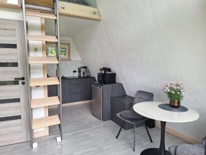 a small kitchen with a table and a table and chairs at Rose Valley Cottage in Ieriķi