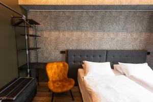 a bedroom with a bed and a desk and a chair at Centrum Hotel in Akureyri
