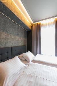 a bedroom with two beds and a window at Centrum Hotel in Akureyri