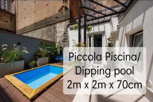 a swimming pool on a patio of a house with the text piscoda pictured at The Tribunali Apartments By HouseinNaples in Naples